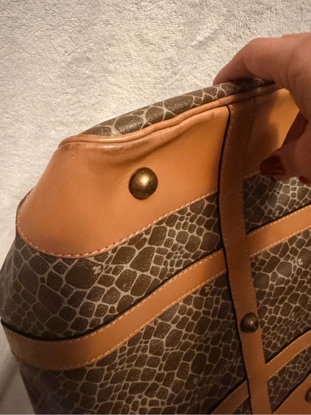 Nina Ricci Brown Patterned Duffel with Tan Trim. Has lock and key.